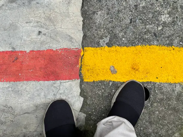 Feet standing next to ground traffic signs and temporary parking prohibited signs, Mastercard Creative.