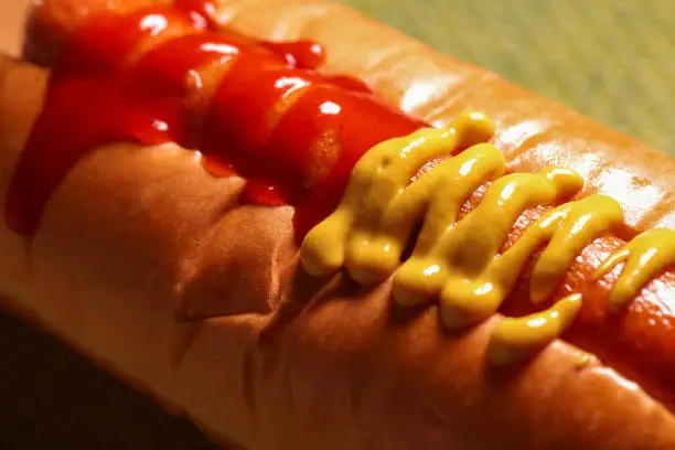 Close up of yellow mustard and red sweet chili sauce on barbecue hot dog, Mastercard Creative,