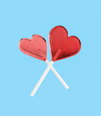 Crossed heart-shaped lollipops floating on a blue isolated background. 3d rendering