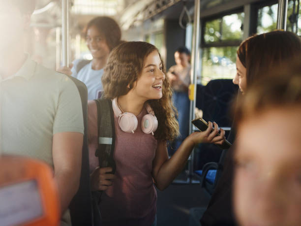 istock Happy students talking while traveling to school in a bus. 1733245171