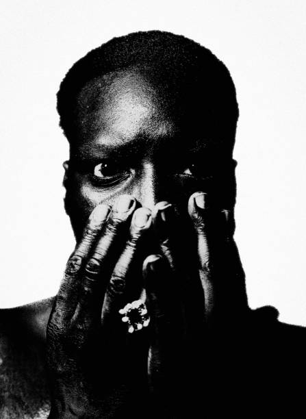 The horror. Portrait of a black man with wide open eyes. He holds his hands in front of his face. Neo-Pictoralism. rough hands man stock pictures, royalty-free photos & images