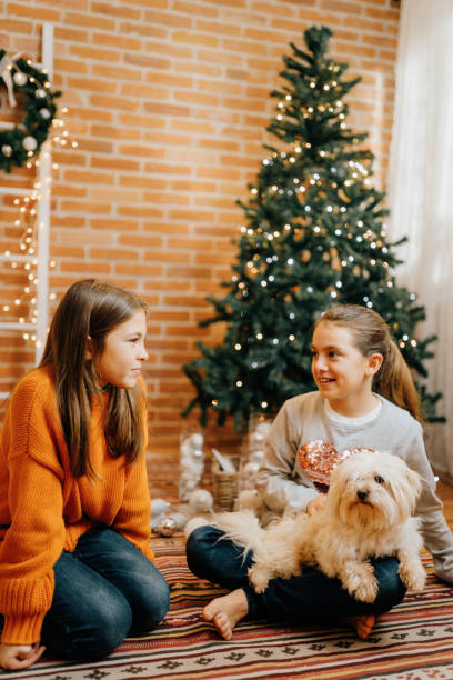 istock Cheerful children decorating the Christmas tree at home 1733283296
