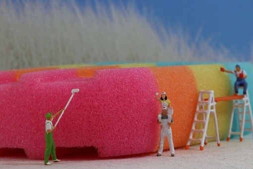 Model people painting an ice lolly