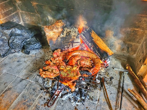 traditional meat roasted in a parrilla under the embers of burning wood, a typical dish from Uruguay