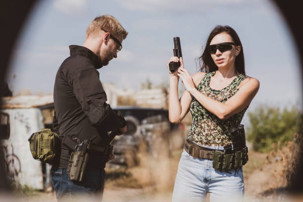 istock A girl learns to shoot a pistol at a shooting range with an instructor 1733352908