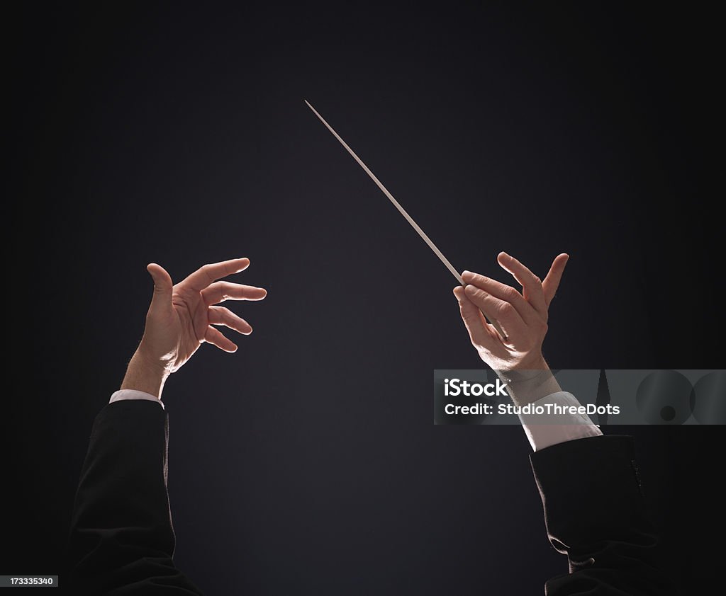 conducting buttons Concert conductor hands with baton over dark background Musical Conductor Stock Photo