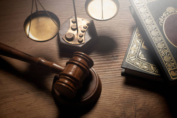 Judge gavel and legal book on wooden table stock photo
