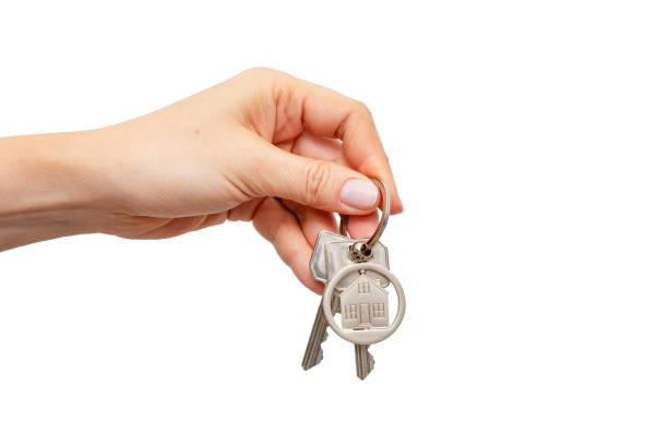 istock Woman holding keys with house shaped keychain 1733369368