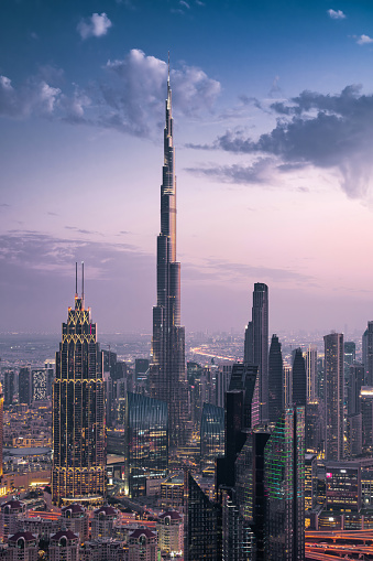 Dubai, United Arab Emirates - March 2, 2023: Futuristic Dubai skyline including architectural landmark Burj Khalifa at dusk in Dubai, United Arab Emirates (UAE).