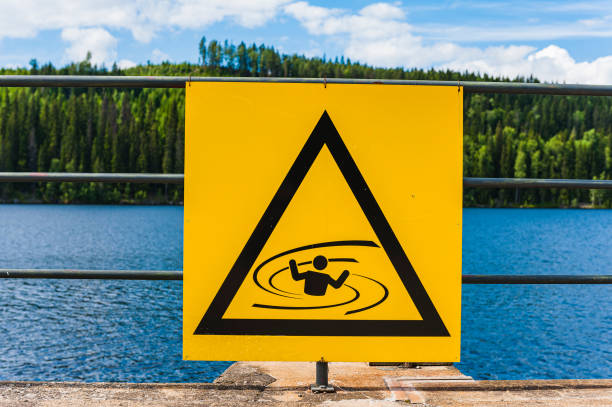 istock A bright yellow warning sign with a triangle shape hovers over turbulent water 1733394277