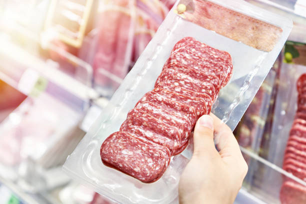 istock Sliced sausage in pack in hands 1733397612