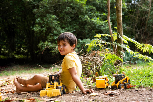 istock boy playing with toy machines in a garden 1733403325