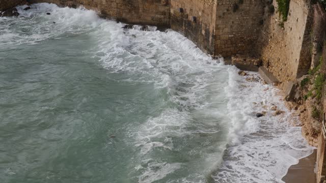 Sea waves hitting the city walls