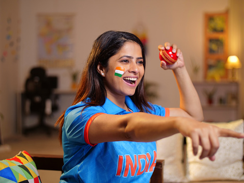 Female Indian cricket fan wearing an Indian jersey - cheering for team, female sports fan, cricket series
