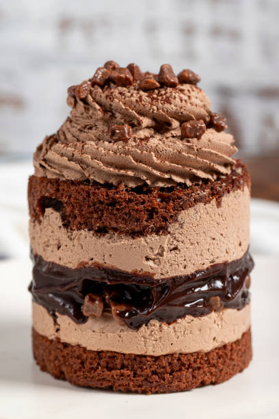 istock Chocolate and cocoa cake. Layer cake with fresh chocolate cream on a plate. Close up 1733468608