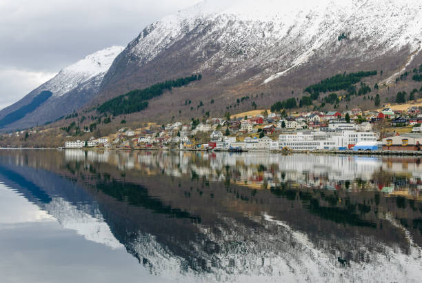 istock small town under mountains that are reflected in the sea 1733468631