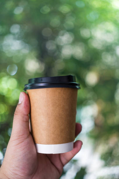 istock Hand holding cup of hot coffee on morning 1733475922
