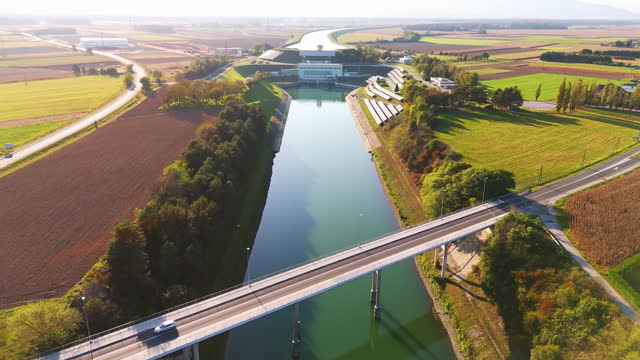 AERIAL Canal Bridge takes Center Stage against Backdrop of Majestic Hydroelectric Plant in Slovenia