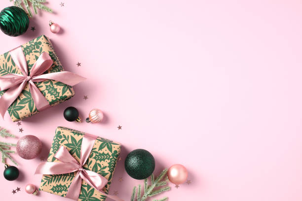istock Overhead view Christmas decorations, gift boxes, fir tree branches, confetti on pastel pink background. Christmas Greeting card design with stylish Xmas ornaments. 1733509435