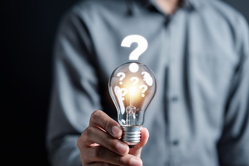 Businessman hand holding light bulb with brain into smart, creative, idea thinking to innovation brainstorm and imagination learning educate concept.