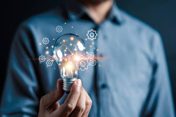 istock Innovation through ideas and inspiration ideas. Human hand holding light bulb to illuminate, idea of creativity and inspiration concept of sustainable business development. 1733514047