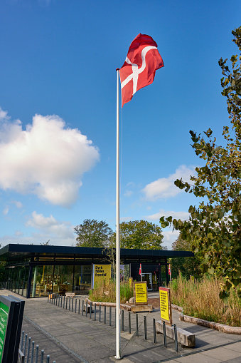 Ticket sale and information outside the museum. The museum contains a collection of buildings from villages from the 19th century. The Danish flag \