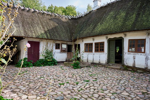 Small family based farm with a farmhouse in open air museum in Odense.  The farmhouse is one of a collection of more than 20 buildings from the 19th century - all together making a complete village representing all functions from blacksmith to shoemaker.
