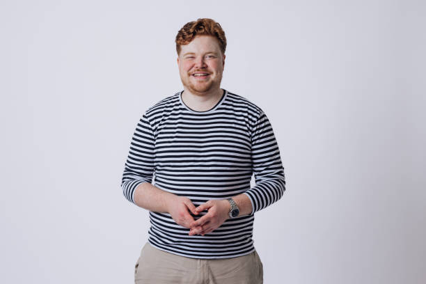 A portrait shot of a male student wearing casual clothing, looking and smiling at the camera.