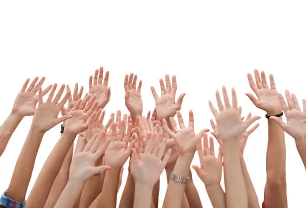 Photo of Group of young people's hands raised up.