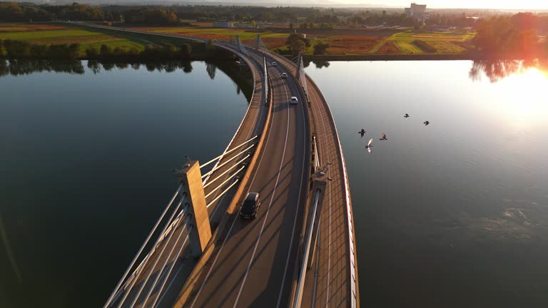 AERIAL Drone shot of Traffic on Bridge over Drava River on Sunny Day in Ptuj, Slovenia