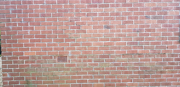 Air vent in an old brick wall.