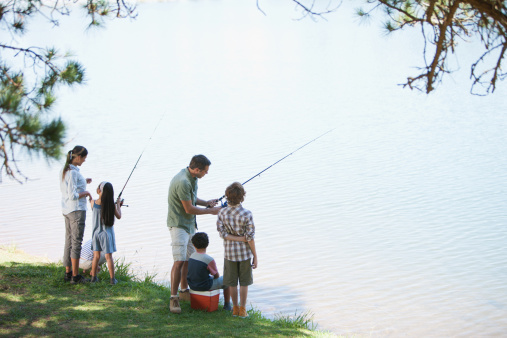 Family enjoying outdoor activities near river