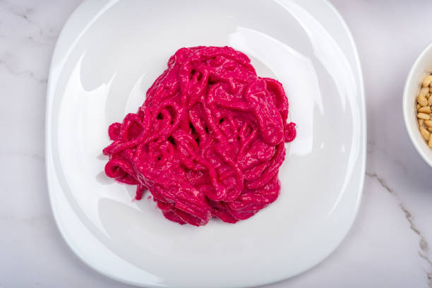 Closeup view of a vibrant salad with diced beetroot, colourful fruits and vegetables in a bowl, creating a visually appealing and healthy dish.
