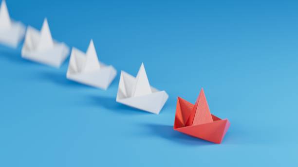istock Different business concept.new ideas. paper art style. creative idea.Leadership concept with red paper ship leading among white.3D rendering on blue background. 1733609922