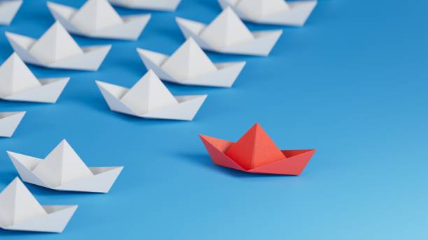 istock Different business concept.new ideas. paper art style. creative idea.Leadership concept. Red leader paper ship leading among white.3D rendering on blue background. 1733609927