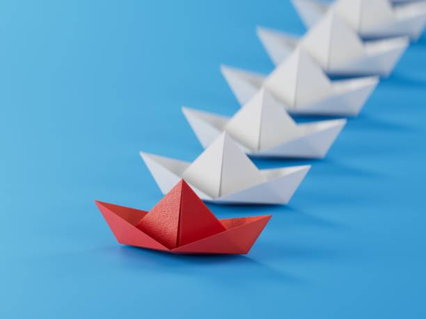 istock Different business concept.new ideas. paper art style. creative idea.Leadership concept using red paper ship among white boats.3D rendering on blue background. 1733610459