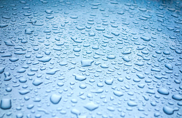 gotas de agua sobre la superficie de cuentas azul. - geschützt fotografías e imágenes de stock