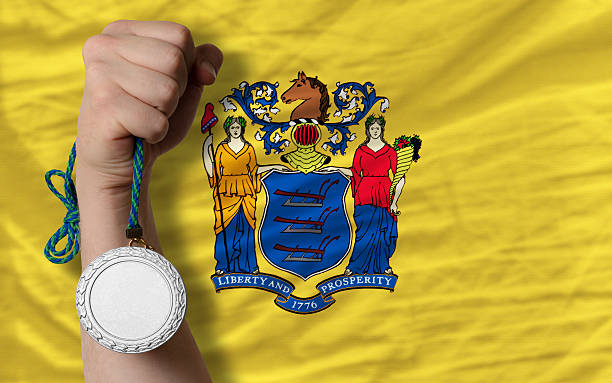 Silver medal for sport and  flag of new jersey Holding silver medal for sport and flag of us state of new jersey jerseyan stock pictures, royalty-free photos & images