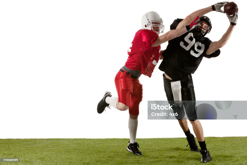 Jogadores de futebol americano em ação - Foto de stock de Campo de Futebol Americano royalty-free