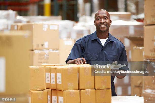 A Worker In A Warehouse Preparing Goods For Delivery Stock Photo - Download Image Now