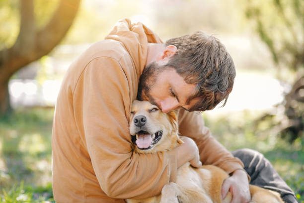 istock Guy and his dog, golden retriever, nature 1733698292