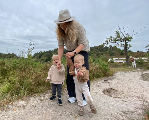 istock Young mother having a walk with her twin 1733698832