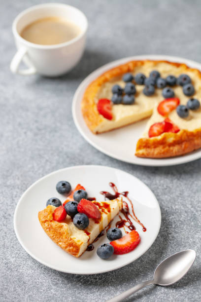 istock Curd casserole piece in a plate with berries on the table. 1733699904