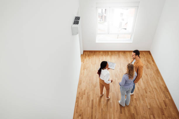 istock Real estate agent talking with couple in new empty apartment 1733700059