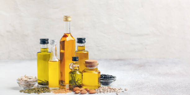 istock Various vegetable and nut oil in bottles on a bright background. 1733707238
