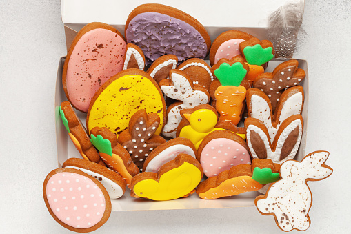 Glazed color gingerbread Easter figures - rabbit, chicken, egg, carrot on a bright background. Happy Easter. Top View