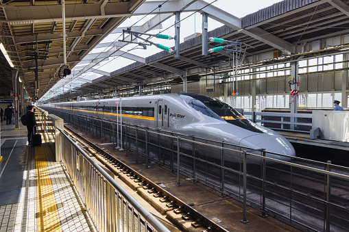 Tokyo, Japan  April 13, 2023: Shinkansen train at a railway station in Tokyo, with unidentified people. The Shinkansen is a network of high-speed railway lines in Japan
