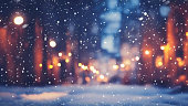 Beautiful background image of a city square on a winter evening with a light snowfall.