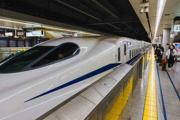 Tokyo, Japan  April 13, 2023: Shinkansen train at a railway station in Tokyo, with unidentified people. The Shinkansen is a network of high-speed railway lines in Japan