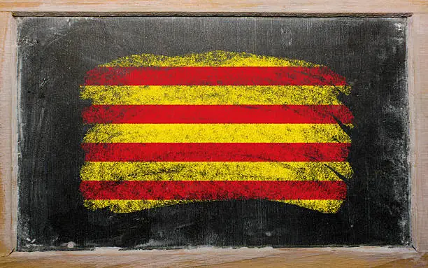Chalky catalonia flag painted with color chalk on old blackboard